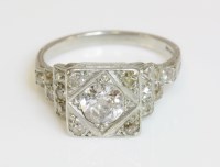 Lot 408 - An Art Deco single stone diamond ring with diamond set shoulders