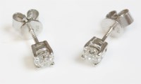 Lot 592 - A pair of white gold single stone diamond stud earrings