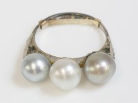 Lot 402 - A three stone cultured pearl ring
