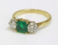Lot 562 - An 18ct gold emerald and diamond three stone ring