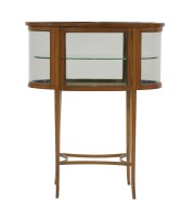 Lot 484 - An Edwardian oval satinwood vitrine