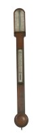 Lot 330 - A walnut stick barometer
