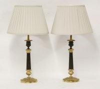 Lot 364 - A pair of Regency bronze and parcel gilt candlesticks