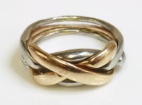 Lot 377 - A gold and platinum four-piece puzzle ring