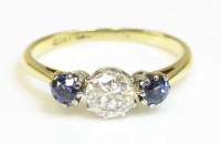 Lot 504 - A three stone diamond and synthetic sapphire ring