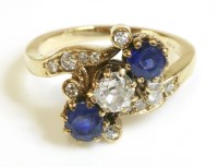 Lot 509 - A Continental diamond and sapphire crossover ring