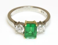 Lot 572 - A platinum and gold three stone emerald and diamond ring by Fred E Ullmann