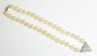Lot 451 - A single row cultured pearl necklace with a diamond cluster centrepiece
