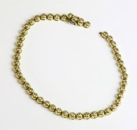 Lot 523 - A gold diamond set line bracelet