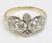 Lot 354 - A four stone diamond cluster ring with diamond set shoulders