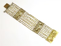 Lot 445 - A Continental ten row gold bracelet with foliate panels