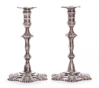 Lot 134 - A pair of cast silver taper sticks