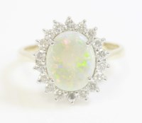 Lot 471 - An 18ct gold opal and diamond oval cluster ring