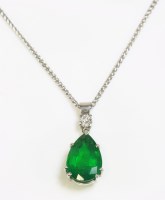 Lot 565 - A two stone emerald and diamond pendant