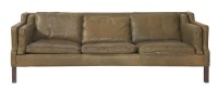 Lot 665 - A brown leather three-seater settee