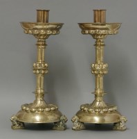 Lot 473 - A pair of Victorian Gothic brass candlesticks