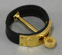 Lot 17 - A boxed Hermès gold-plated and black lizard skin scarf ring