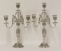 Lot 16 - A pair of Persian metalwares three light candelabra