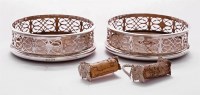 Lot 65 - A pair of silver wine coasters