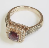 Lot 463 - A rose gold garnet and diamond cushion shaped cluster ring