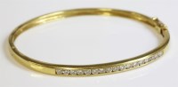 Lot 493 - An 18ct gold diamond set hinged bangle
