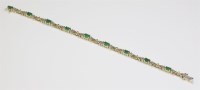 Lot 499 - An American emerald and diamond line bracelet