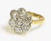 Lot 508 - An 18ct gold seven stone diamond daisy cluster ring