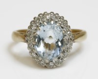 Lot 438 - An aquamarine and diamond oval cluster ring