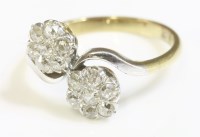 Lot 375 - A double cluster diamond crossover ring