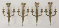 Lot 452 - A set of four gilt bronze twin branch wall lights
