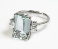 Lot 434 - A white gold single stone aquamarine ring with diamond set shoulders