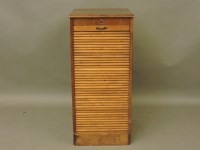 Lot 614 - An oak tambour front cabinet