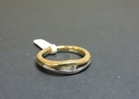 Lot 56 - An 18ct yellow and white single stone diamond wave ring