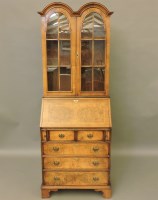 Lot 663 - A Queen Anne style walnut bureau bookcase