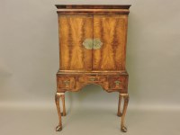 Lot 648 - A Queen Anne style walnut cocktail cabinet