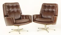 Lot 451 - A pair of Danish brown leather swivel armchairs (2)