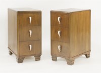 Lot 207 - A pair of walnut three-drawer bedside chests