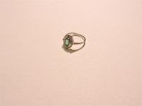 Lot 3 - An emerald and diamond oval cluster ring