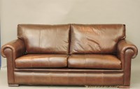 Lot 734 - A modern brown leather settee