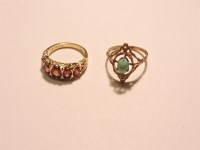 Lot 58 - A 9ct gold five stone garnet carved head style ring