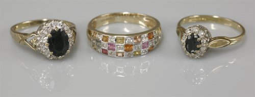 Lot 1043 - A 9ct gold sapphire and diamond oval cluster ring