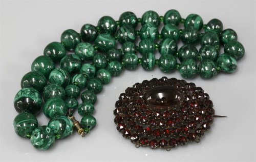 Lot 1054 - A Bohemian cabochon and rose cut garnet oval cluster brooch