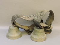 Lot 1384 - Two old cowbells and neck straps