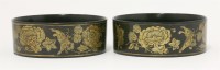 Lot 137 - A pair of black lacquered papier mâché wine coasters