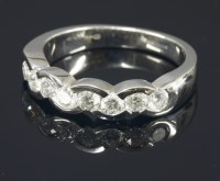Lot 650 - An 18ct white gold diamond set half eternity ring