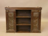 Lot 657 - An Arts and Crafts oak wall cupboard
