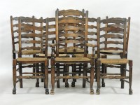 Lot 730 - A set of eight oak and rush seated ladder back dining chairs
