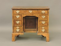 Lot 583 - An 18th century style walnut veneered kneehole desk