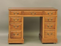Lot 647 - A walnut pedestal desk