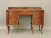 Lot 612 - A walnut kidney shaped desk